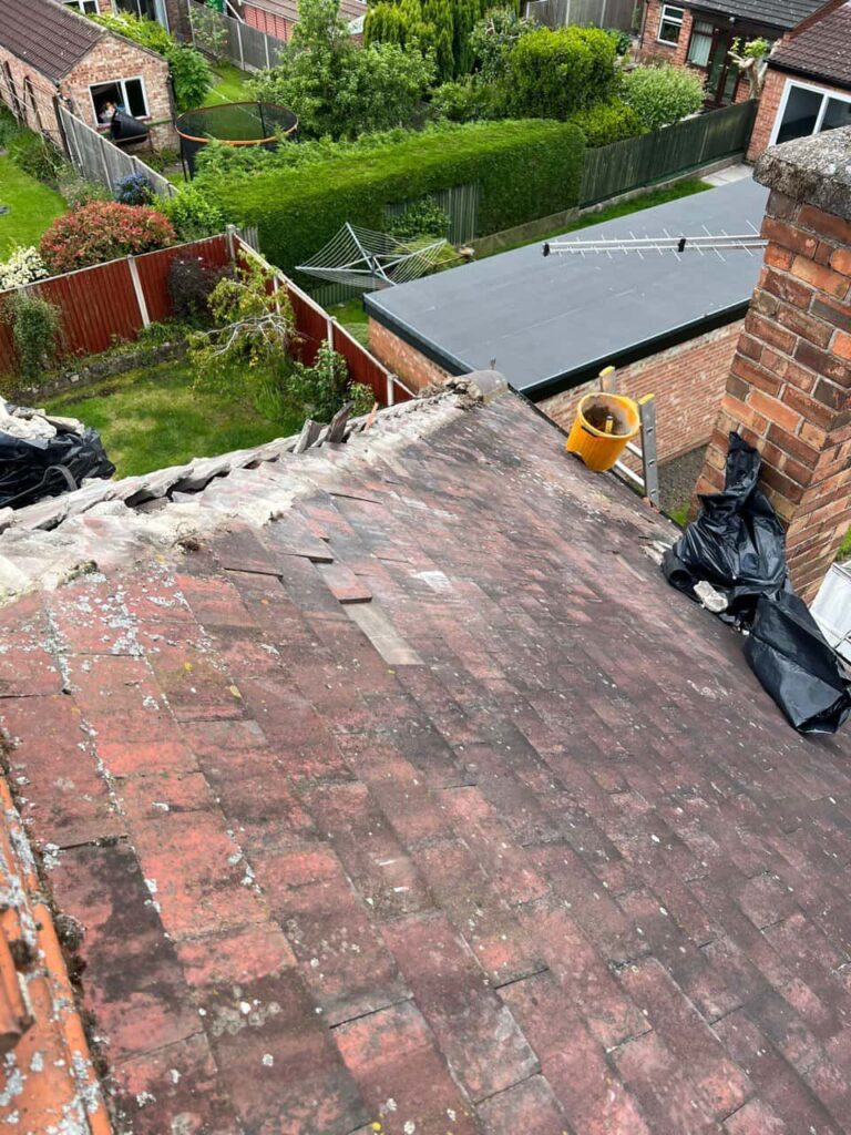 This is a photo of a roof where the hip tiles have been removed, and are just about to be replaced. Works carried out by Ilkeston Roofing Repairs